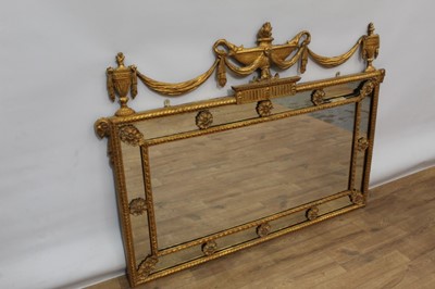 Lot 1384 - Good quality Classical revival gilt gesso wall mirror, with central rectangular plate and peripheral plates, boss divisions and urn and swag cresting, probably late 19th / early 20th century, 138 x...