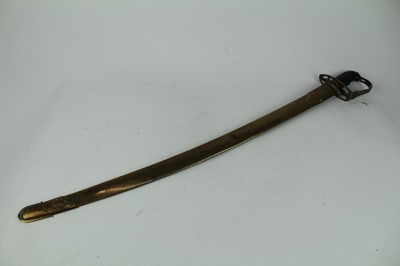 Lot 888 - Indian military sword with ribbed wooden grip, brass stirrup hilt with curved polished steel blade, in brass scabbard, 82.5cm in overall length.