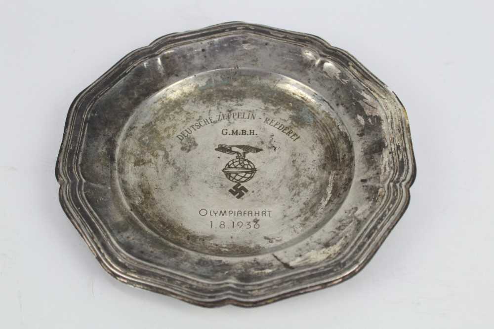 Lot 734 - Zeppelin Interest- 1930's German silver plated plate, engraved 'Deutsche Zeppelin - Reederei, G.M.B.H. Olympiafahrt 1. 8. 1936' 21.8cm in diameter.