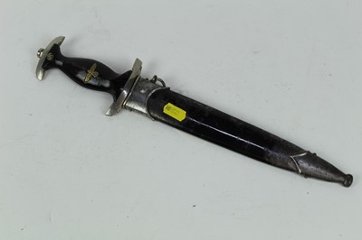 Lot 874 - Post Second World War copy of a Nazi 1933 pattern SS mans dagger, with black painted wood grip, inset SS insignia and Nazi Eagle, polished steel blade etched 'Meine Ehre heisst Treue', in scabbard.