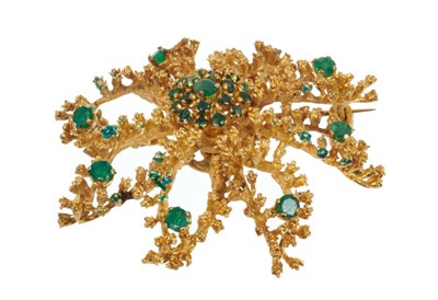 Lot 491 - Gold and emerald brooch in the form of a stylised flower, stamped K18. Approximately 50mm.