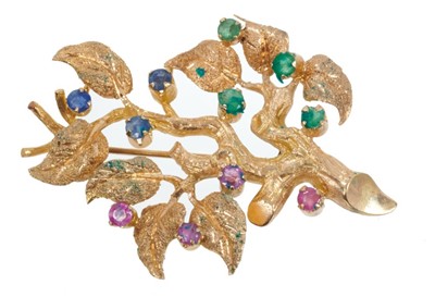 Lot 492 - Gold and multi-gem brooch in the form of a tree with textured gold leaves and set with sapphires, rubies and emeralds. Approximately 55mm.