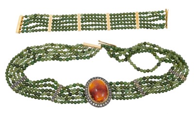 Lot 480 - Unusual diamond, amber and green stone necklace with a central oval amber cabochon surrounded by rose cut diamond border, on five strands of green stone beads with spacers, approximately 48cm.