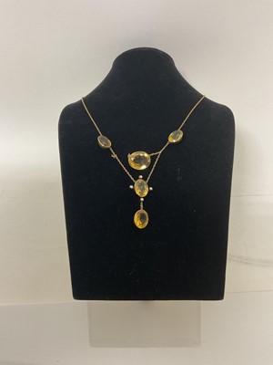 Lot 463 - Edwardian citrine and seed pearl necklace with oval mixed cut stones in gold rub over settings, together with a pair of pendant earrings.