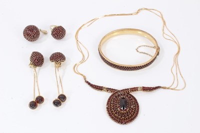 Lot 493 - Garnet suite of jewellery to include a necklace, hinged bangle, pair of pendant earrings, ball pendant and dress ring with pavé set stones in yellow metal and gilt metal settings