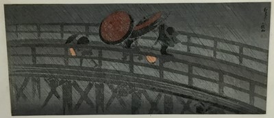 Lot 63 - Japanese colour woodblock, - figures on a bridge in rain 36.5cm x 16cm mounted in glazed frame