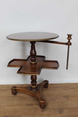 Lot 1458 - Regency style mahogany and gilt painted reading table, with adjustable brass candle arm and circular tier over shaped galleried tier on triform platform base with bun feet and castors, 50cm wide