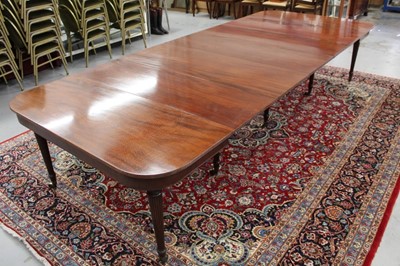 Lot 1462 - Good Regency mahogany dining table, with twin D-ends raised on ring turned legs and and castors, including five additional leaves, 143cm wide x 116cm extending to approximately 350cm