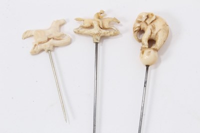 Lot 698 - Three 19th century novelty hatpins - ivory elephant on ball, race horse and horse (3)