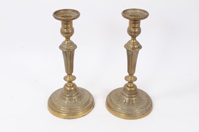 Lot 1519 - Pair of antique brass candlesticks of classical style