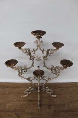 Lot 1474 - Antique cast iron plant stand, with six dished holders (one missing) issuing from scrolled frame on scrolling splayed supports, 92cm wide x 108cm high