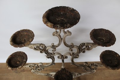 Lot 1474 - Antique cast iron plant stand, with six dished holders (one missing) issuing from scrolled frame on scrolling splayed supports, 92cm wide x 108cm high