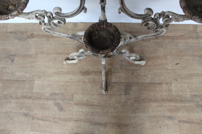 Lot 1474 - Antique cast iron plant stand, with six dished holders (one missing) issuing from scrolled frame on scrolling splayed supports, 92cm wide x 108cm high