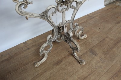 Lot 1474 - Antique cast iron plant stand, with six dished holders (one missing) issuing from scrolled frame on scrolling splayed supports, 92cm wide x 108cm high