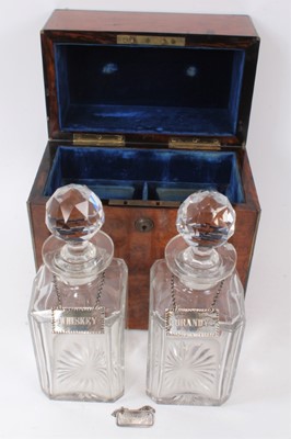 Lot 699 - Good mid 19th century burr walnut and brass bound decanter box, enclosing two cut glass decanters and stoppers, each with silver spirit label, also together with another spirit label, the box with...