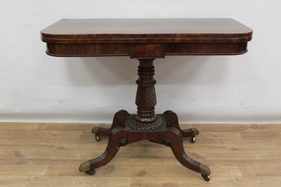 Lot 1518 - Regency plum pudding mahogany card table, with D-shaped fold over top and beaded tablet frieze on spiral twist column and reeded cabriole legs with brass cappings and castors, 91cm wide x 46cm deep...