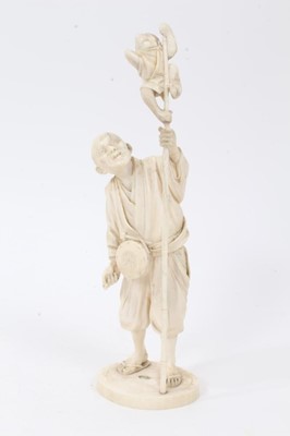 Lot 742 - Japanese Meiji carved ivory okimono, depicting a man and pet monkey up a pole, signed to base, total height 28cm