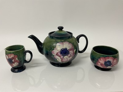 Lot 1098 - Moorcroft pottery poppy pattern teapot with sugar bowl and milk jug