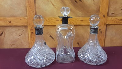 Lot 1161 - Three silver mounted glass decanters