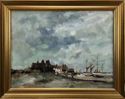 Lot 31 - Manner of Edward Seago (1910-1974), oil on canvas - a coastal scene with sailing vessels moored by buildings, 35 x 45cm in gilt frame