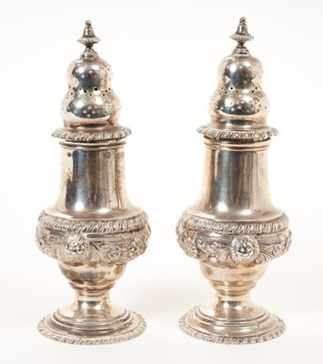 Lot 311 - Pair of 1920s silver  George style pepperettes with gadrooned borders, Hallmarked London 1928