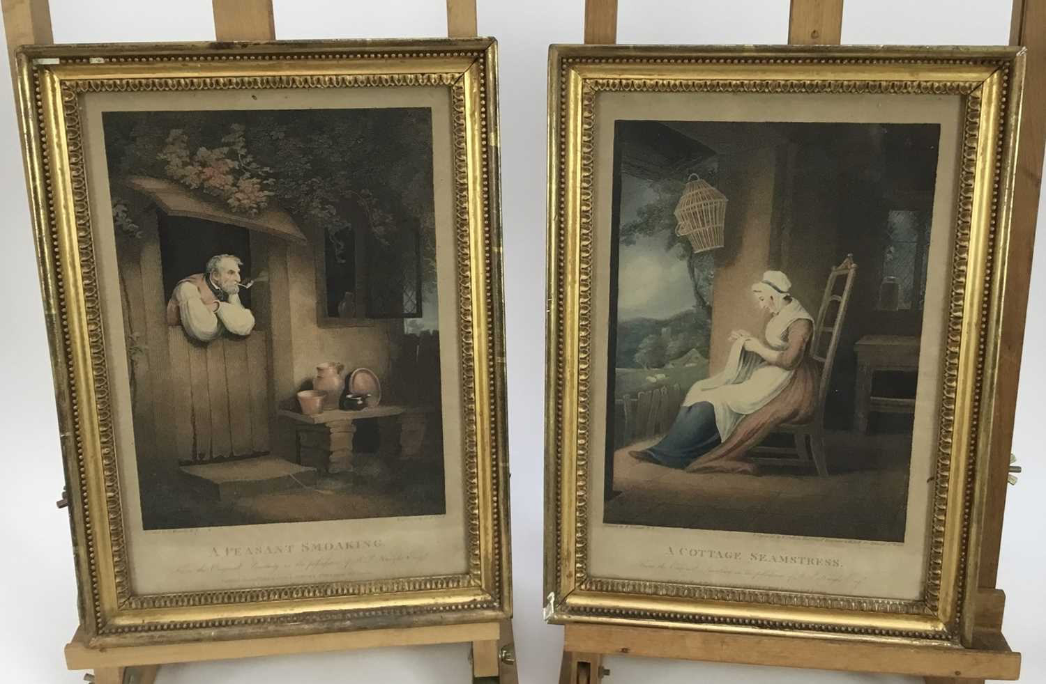Lot 128 - A pair of hand coloured 19th century stipple engravings - 'A Peasant Smoking' and 'A Cottage Seamstress', pub. London 1802 Clay & Scriven, both images 20cm x 28cm, in glazed frames (2)