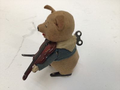 Lot 1894 - Schuco clockwork model of a pig playing the violin, together with a German clockwork rabbit (2)