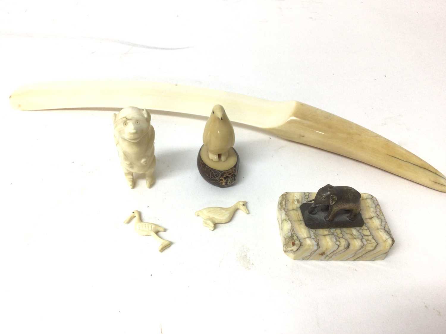 Lot 46 - Group of items to include a fossilised mammoth tooth slab mounted with Indian silver elephant, Victorian ivory letter opener, antique ivory monkey, and a vegetable ivory bird