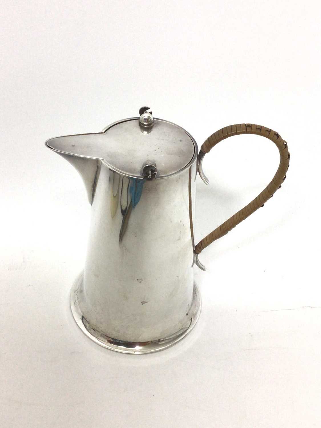 Lot 52 - Arts & Crafts silver water pot with gimbled hinged lid and caned handle by Barker Bros. (Chester 1926)