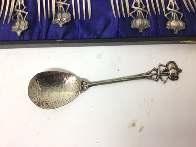 Lot 53 - Set of Art Nouveau silver plated dessert cutlery comprising six spoons and six forks with hammered bowls and poppy head terminals ro the handles, in fitted box
