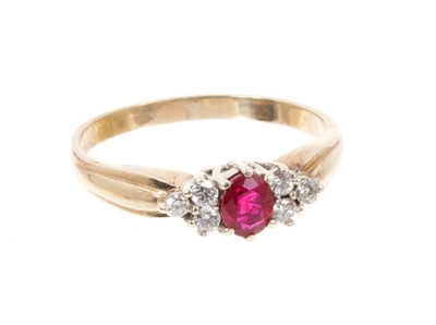 Lot 542 - Ruby and diamond ring with an oval mixed cut ruby flanked by six brilliant cut diamonds in 9ct yellow gold setting