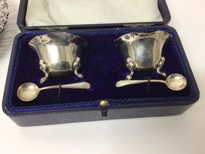 Lot 73 - Silver hot water/hot milk jug, set of twelve silver teaspoons and sugar tongs in fitted case, pair of silver salts with spoons on original fitted box, silver two handled trophy and a silver bon bon...