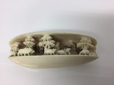 Lot 11 - 19th century Japanese ivory clam shell diorama, the inside with figures, livestock, trees and buildings, 10cm across
