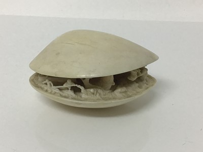 Lot 12 - 19th century Japanese ivory clam shell diorama, the inside with figures attempting to catch a large fish, signed underneath 9cm across