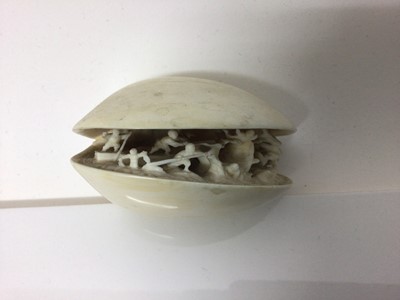 Lot 12 - 19th century Japanese ivory clam shell diorama, the inside with figures attempting to catch a large fish, signed underneath 9cm across