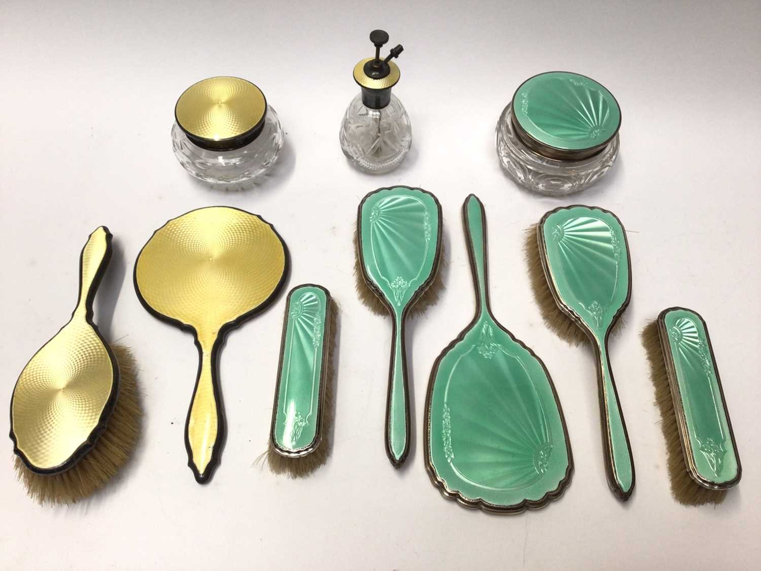 Lot 124 - Art Deco silver and yellow guilloché enamel four piece dressing table set and one other