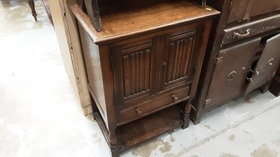 Lot 886 - Small oak cupboard with pair of panelled doors with carved linen fold decoration above single draw.