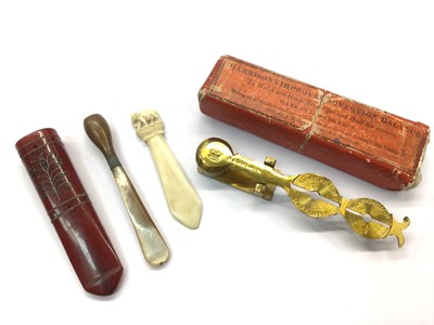 Lot 406 - Set of Harrison's brass sovereign scales in box, two cheroot holders and ivory bookmark