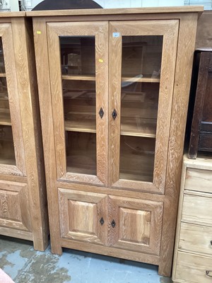 Lot 887 - Good quality contemporary limed oak glazed bookcase with adjustable shelves enclosed by two glazed doors, with two panelled doors below