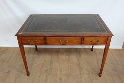 Lot 1007 - Reproduction mahogany writing table with green leather lined top and three drawers, three dummy drawers opposing, on square taper legs and spade feet