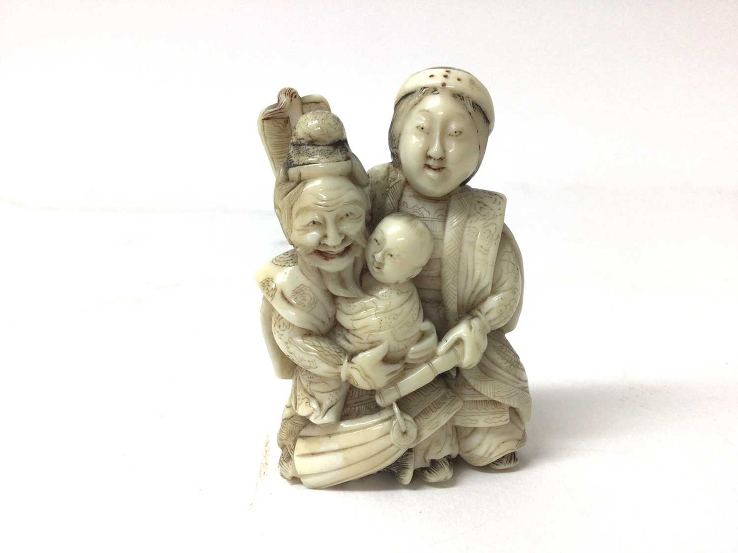 Lot 36 - 19th century Japanese ivory figure group of a samurai, wife and child, 6.5cm high