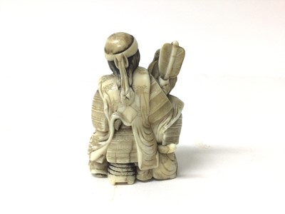 Lot 36 - 19th century Japanese ivory figure group of a samurai, wife and child, 6.5cm high