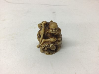 Lot 41 - 19th century ivory netsuke of a figure on a rock holding a staff with a toad at his feet