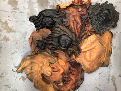 Lot 634 - Moulded leather faces and other pressings