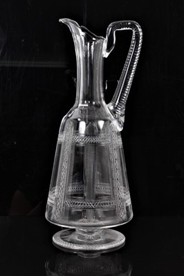 Lot 191 - 1870s aesthetic movement footed crystal claret jug with finely cut geometric decoration, the design possibly influenced by Christopher Dresser