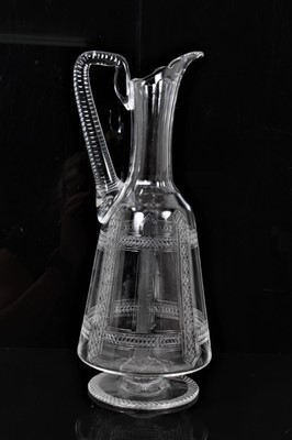 Lot 191 - 1870s aesthetic movement footed crystal claret jug with finely cut geometric decoration, the design possibly influenced by Christopher Dresser