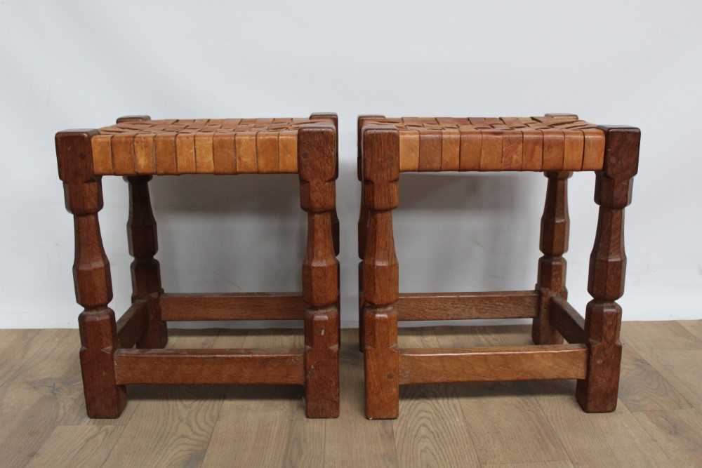 Lot 1323 - Pair of oak and woven leather stools, by David Langstaff in the Mouseman tradition