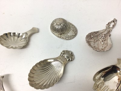 Lot 114 - Seven sterling silver caddy spoons, 1916 and later, including jockey cap, seahorse, hand, acorn, etc