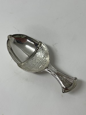 Lot 114 - Seven sterling silver caddy spoons, 1916 and later, including jockey cap, seahorse, hand, acorn, etc