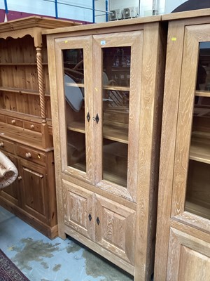 Lot 888 - Good quality contemporary limed oak bookcase with adjustable shelves enclosed by two glazed doors, with two panelled doors below, 101cm wide, 40cm deep, 181cm high